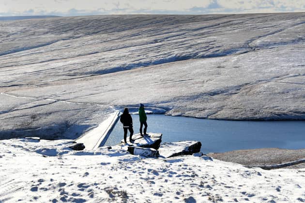 Walkers  are pictured in wintery conditions at March Haigh Reservoir at Marsden Moor, West Yorkshire. Picture by Simon Hulme 16th January 2023