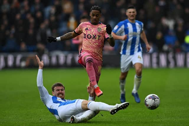 Leeds United's Crysencio Summerville loses out to Huddersfield Town's Danny Ward. Picture: Jonathan Gawthorpe.