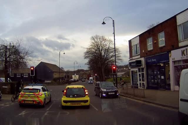 Dashcam footage appears to show bike-riding youths chucking objects at a police car