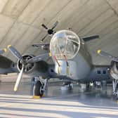 A B17 bomber aircraft, with Mustang fighter overhead in Duxford’s American Hangar