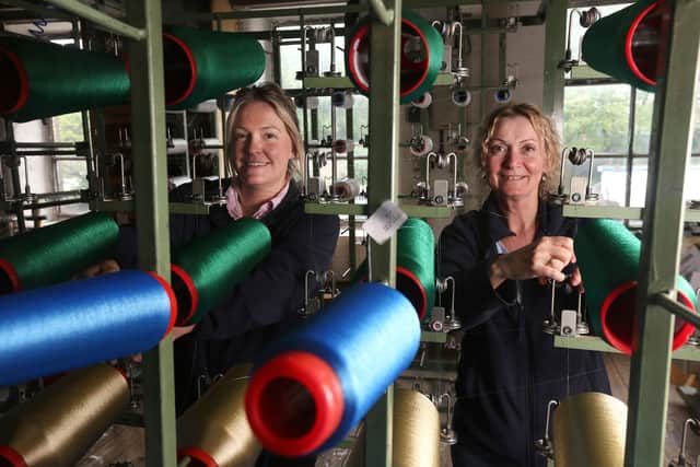 Susannah Wright (left) and Jeanie Dixon work on a warping machine producing braid for military medals at Wyedean, in Haworth. Lorne Campbell/Guzelian