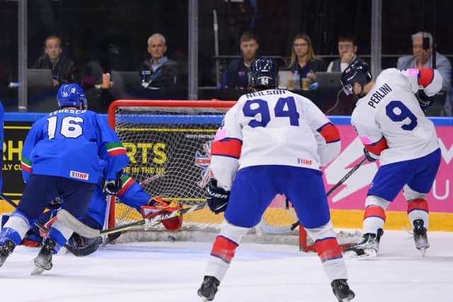 RIGHT PLACE< RIGHT TIME: Brett Perlini (No 9) taps home the puck at the back post off a pass from Mike Hammond to make it 4-3 against Italy at Nottingham's Motorpoint Arena. Picture: Dean Woolley/Ice Hockey UK
