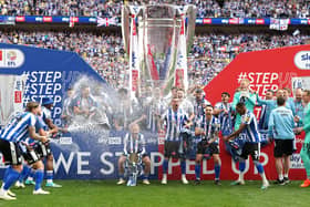 MOVING ON UP: Sheffield Wednesday's players celebrate with the trophy after their stunning 1-0 victory over Barnsley in extra-time in the League One play-off final at Wembley Stadium Picture: Nick Potts/PA