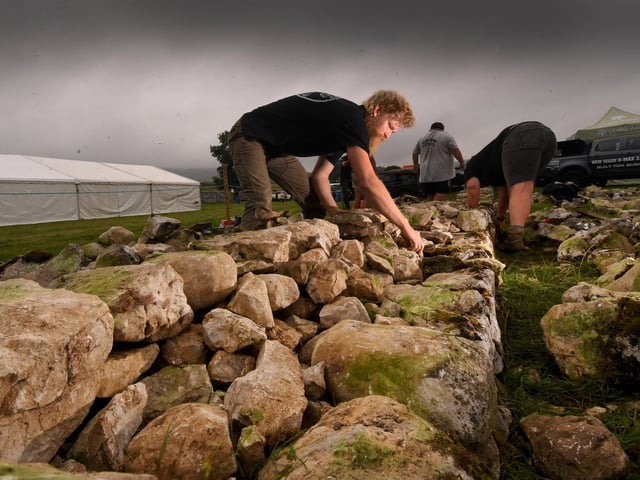 Under dark shies Roger Burrows is pictured taking part in the Dry Stone Wall competition at the show