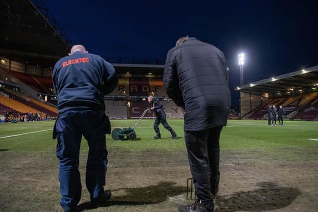 PITCH BATTLE: Bradford City groundstaff work on the Valley Parade pitch before kick-off