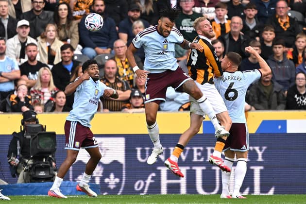 AERIAL BATTLE: Aston Villa's Tyrone Mings (centre) competes with Oli McBurnie for the ball (Image: Press Association)