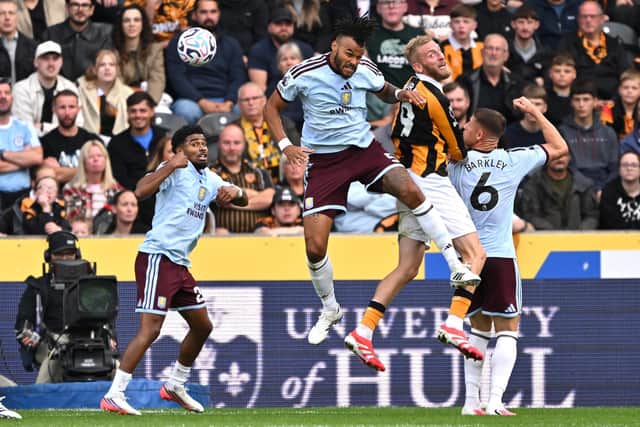 AERIAL BATTLE: Aston Villa's Tyrone Mings (centre) competes with Oli McBurnie for the ball (Image: Press Association)