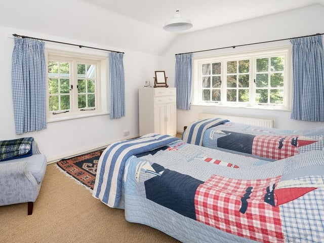 The first floor offers access to five double bedrooms, each with breath-taking views towards woodland, open countryside or the sea. A separate staircase leads to an attic room with eaves storage, currently utilised as a sixth bedroom.