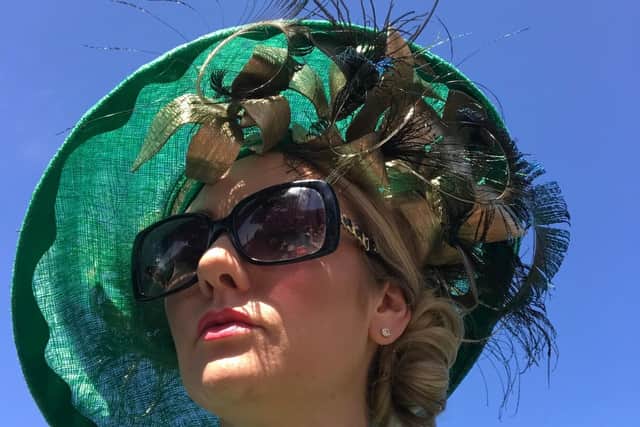 Green and black hat with feathers by Jenny Roberts Millinery, worn by Rebecca Dixon