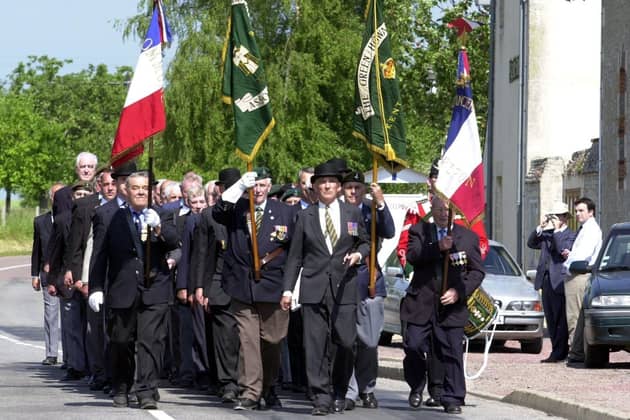 D-Day remembrance at Normandy, France, in 2004, with members of the Green Howards association parading to the Green Howards' memorial in Crepon. PIC: Chris Lawton