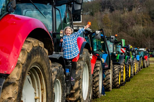 Lilly Galloway, aged 8, of Wetherby waves from the steps of a CASE PUMA 140 tractor in the convoy of vehicles parked at Niddedale Showground for a short break before continuing their onward journey to Greenhow, Menwith Hill, Hampsthwaite, Birstwith, Ripley and returning back to Knaresborough. Picture: James Hardisty.