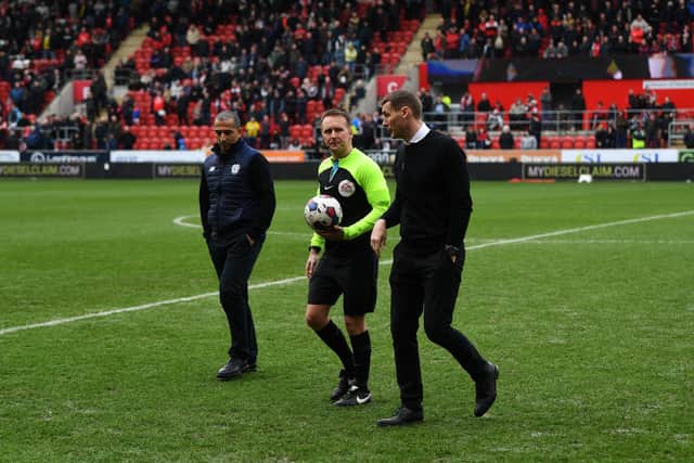 Rotherham United v Cardiff City. Referee Oliver Langford walks off the pitch with the managers Matt Taylor and Sabri Lamouchi. Picture Jonathan Gawthorpe