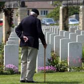 A Normandy veteran, Eric Barley, looks at grave stones before a memorial service in Ranville War Cemetery on June 5, 2013 near Caen, France. (Photo by Matt Cardy/Getty Images)