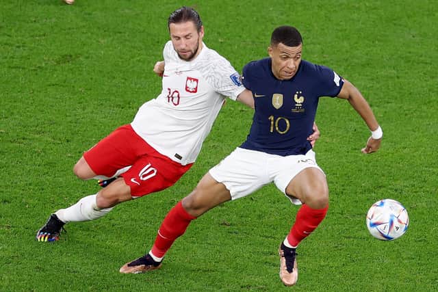 Kylian Mbappe #10 of France and Grzegorz Krychowiak #10 of Poland go after the ball during the FIFA World Cup Qatar 2022 Round of 16 match. (Picture: Elsa/Getty Images)