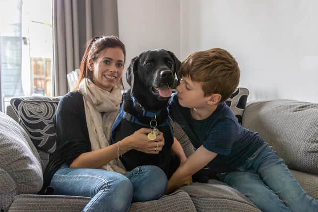Elvis supports the Wilson family. Mum Rebecca is pictured here with Eli, seven. Photo: Support Dogs