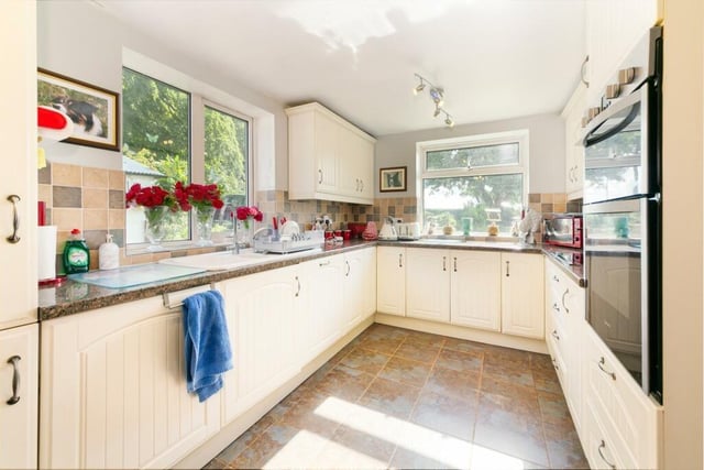 The well equipped kitchen is filled with natural light