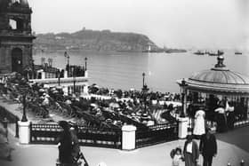 Holiday crowds listen to the band playing in the bandstand at the Spa, Scarborough circa 1913.