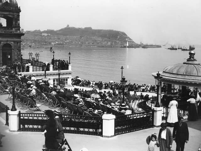 Holiday crowds listen to the band playing in the bandstand at the Spa, Scarborough circa 1913.