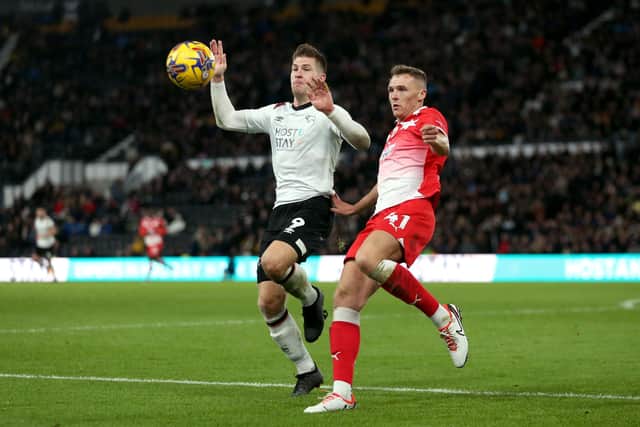 Derby County's James Collins (left) and Barnsley's Jack Shepherd (right) battle for the ball during the recent Sky Bet League One match at Pride Park. Picture: Barrington Coombs/PA Wire.