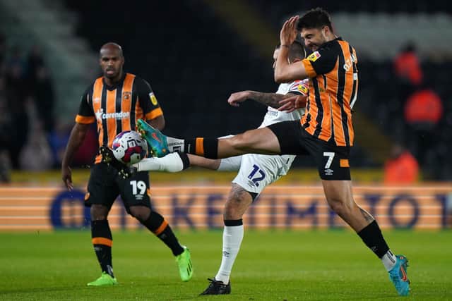 Luton Town's Henri Lansbury (centre) and Hull City's Ozan Tufan battle for the ball during the Sky Bet Championship match at MKM Stadium, Hull. Picture date: Friday September 30, 2022. PA Photo. See PA story SOCCER Hull. Photo credit should read: Tim Goode/PA Wire.

RESTRICTIONS: EDITORIAL USE ONLY No use with unauthorised audio, video, data, fixture lists, club/league logos or "live" services. Online in-match use limited to 120 images, no video emulation. No use in betting, games or single club/league/player publications.