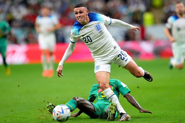 IMPRESSIVE: England's Phil Foden evades being tackled by Senegal's Youssouf Sabaly as they battle for the ball at the Al-Bayt Stadium, Qatar. Picture: Martin Rickett/PA