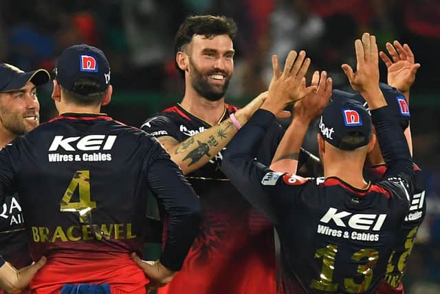 SHORT-LIVED: Royal Challengers Bangalore's Reece Topley celebrates with team-mates after taking a wicket against IPL rivals Mumbai Indians - but he was to return home early through injury. Picture: Manjunath Kiran/AFP via Getty Images.