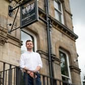 Tom Wright, senior chartered building surveyor at Silverstone Building Consultancy’s Leeds office, outside The Harrogate Inn. (Photo supplied by Silverstone)