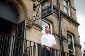 Tom Wright, senior chartered building surveyor at Silverstone Building Consultancy’s Leeds office, outside The Harrogate Inn. (Photo supplied by Silverstone)