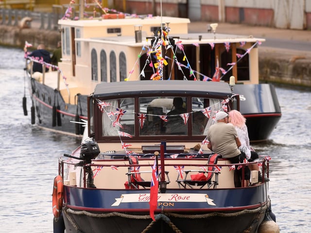 Boats decorated with bunting and flags sail through the docks as part of the flotilla celebrating 200 years since Goole officially opened