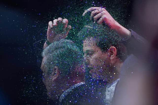 A protester throws glitter over and disrupts Labour leader Sir Keir Starmer making his keynote speech during the Labour Party Conference in Liverpool. PIC: Peter Byrne/PA Wire