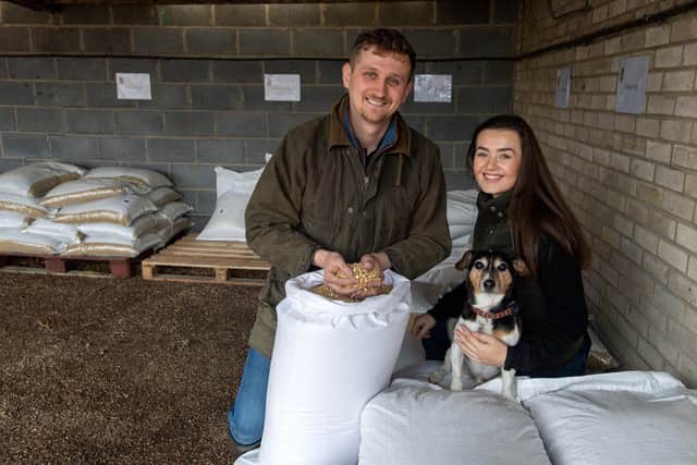 Ben Middleton and his girlfriend Amber Johnson and Dave the dog with some of  the grain and oats they sell.