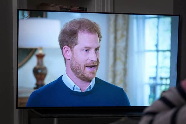 A person at home watching the Duke of Sussex being interviewed by ITV's Tom Bradby during Harry: The Interview, before his controversial autobiography Spare is published. PIC: Jane Barlow/PA Wire