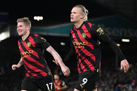Manchester City's Norwegian striker Erling Haaland (R) celebrates scoring his team's second goal with Manchester City's Belgian midfielder Kevin De Bruyne (L) during the English Premier League football match between Leeds United and Manchester City at Elland Road in Leeds, northern England on December 28, 2022. (Photo by OLI SCARFF/AFP via Getty Images)
