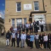 MHA staff in front of the firm's head office in Bradford.