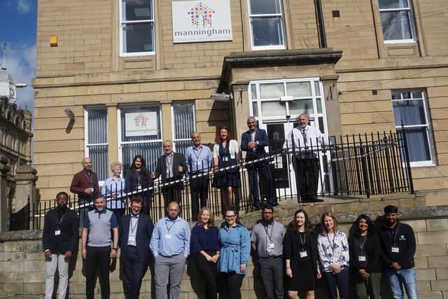 MHA staff in front of the firm's head office in Bradford.