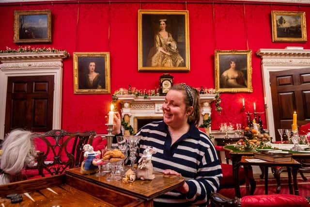 Rachel Wallis, Collection Manager for Fairfax House, in the Saloon Room arranging a few of the 200 townmice which are on display as part of the exhibition.