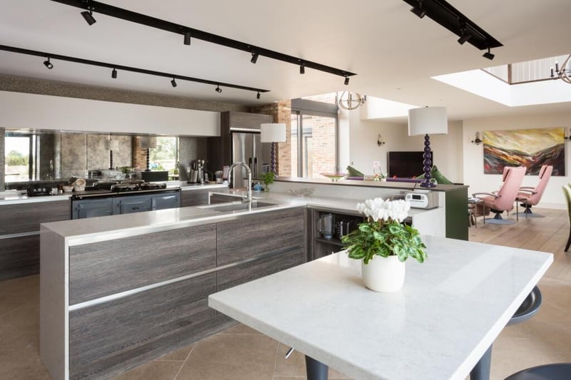 The kitchen includes Neff appliances, a four oven electric controllable Aga with foxed'mirror feature splashback, double Novy extractor vented to outside and a Quooker instant boiling water tap.