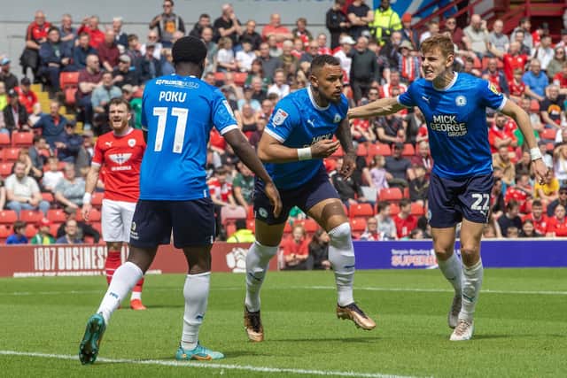 Peterborough United’s Jonson Clarke-Harris celebrates scoring against Barnsley in the win that books them a play-off semi-final with Sheffield Wednesday (Picture: PA)