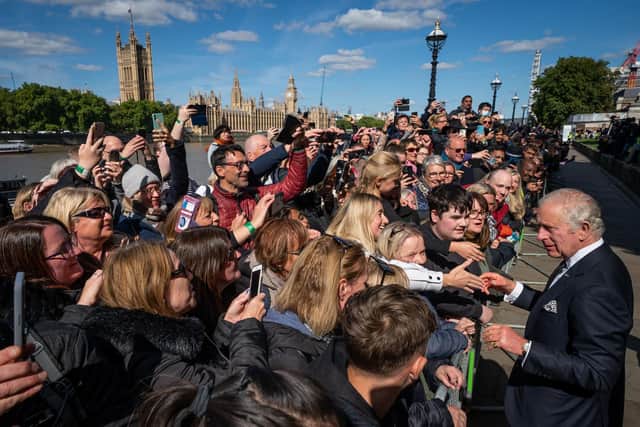 King Charles III meets members of the public in the queue along the South Bank, near to Lambeth Bridge, as they wait to view Queen Elizabeth II lying in state  (Photo by Aaron Chown-WPA Pool/Getty Images)