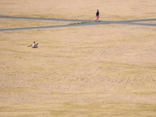 Library image of people walking in the sun in Greenwich Park, south east London, during the heatwave in the summer of 2022. (Photo by Dominic Lipinski/PA)