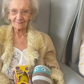 Elderly resident with Easter Egg and Bright Horizons mascot