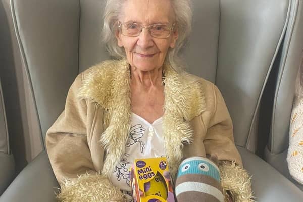 Elderly resident with Easter Egg and Bright Horizons mascot