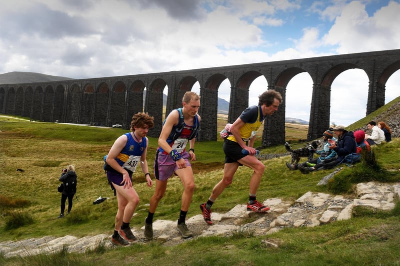 The Three Peaks Race. Runners are pictured running by Ribblehead Viaduct.Picture taken by Yorkshire Post Photographer Simon Hulme 27th April 2024
