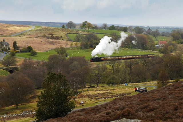 The first day of the summer season for The North Yorkshire Moors Railway. People stop to watch as the train heads over the North Yorkshire Moors towards Pickering Station.