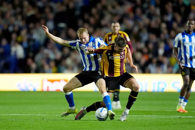 Sheffield Wednesday's Billy Mitchell and Bradford City's Jake Beesley battle for the ball during the Sky Bet League One match at Hillsborough Stadium, Sheffield. Picture date: Thursday August 20, 2026.