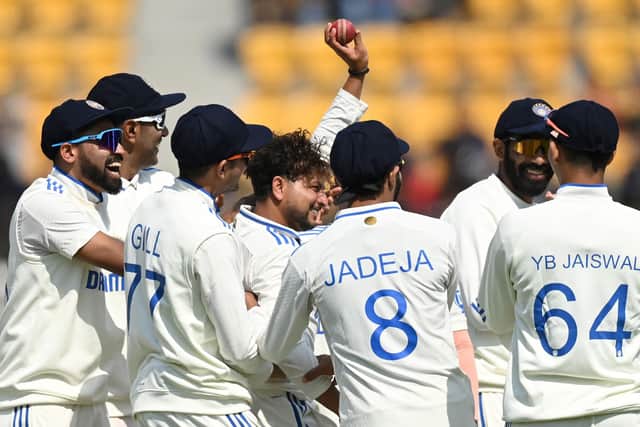 England in a spin: Kuldeep Yadav holds the ball aloft after taking his fifth wicket as the hosts took control on the opening day. Photo by Gareth Copley/Getty Images.