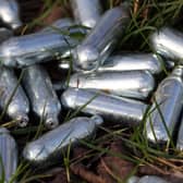 Canisters of nitrous oxide, or laughing gas, discarded by the side of a road. PIC: Gareth Fuller/PA Wire