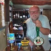 The owner of Green Dragon behind the bar. (Pic credit: D Mark Thompson)