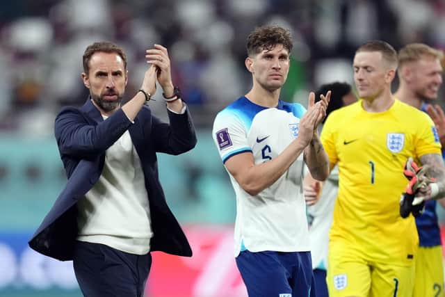 THANKING YOU: England manager Gareth Southgate and defender John Stones (right) show their appreciation to the travelling support after their 6-2 win over Group B rivals Iran at the Khalifa International Stadium, Doha. Picture: Nick Potts/PA