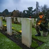 Army cadet Eden Grundy lays a candle at a fallen Canadian grave at the Candlelit Christmas Remembrance event held at the Commonwealth War Graves Commission's (CWGC) Stonefall Cemetery in Harrogate. Picture Tony Johnson